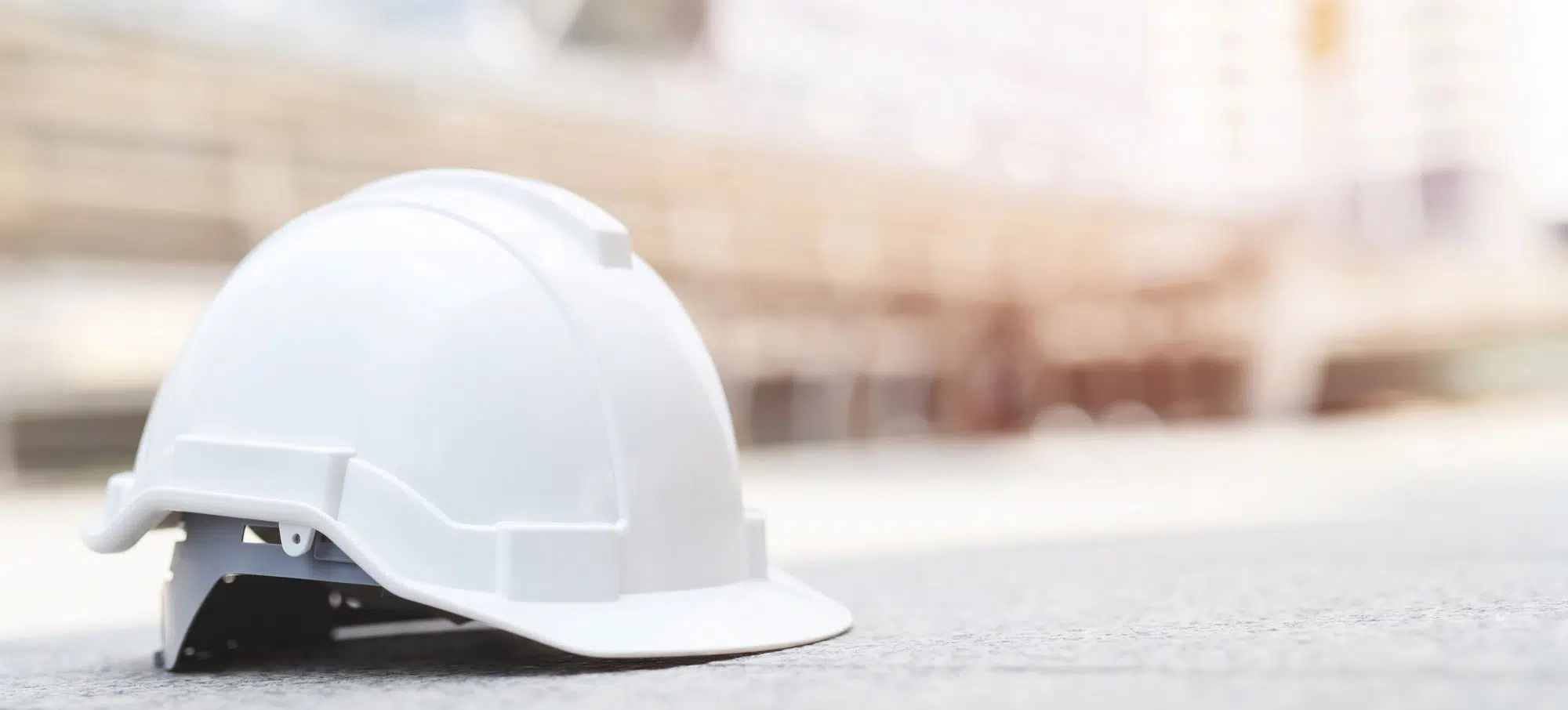 White Hard Safety Wear Helmet Hat In The Project At Construction